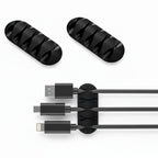 attache câble adhésif noir sur fond blanc