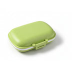 boîte à pilule de couleur vert sur fond blanc