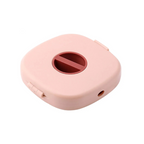 enrouleur de rangement pour câbles de couleur rose sur fond blanc