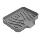 porte savon de couleur gris sur fond blanc